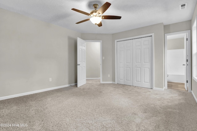 1912 Paulette Rd, Morehead City, NC 28557 - unfurnished bedroom featuring carpet floors, a textured ceiling, baseboards, a closet, and a ceiling fan