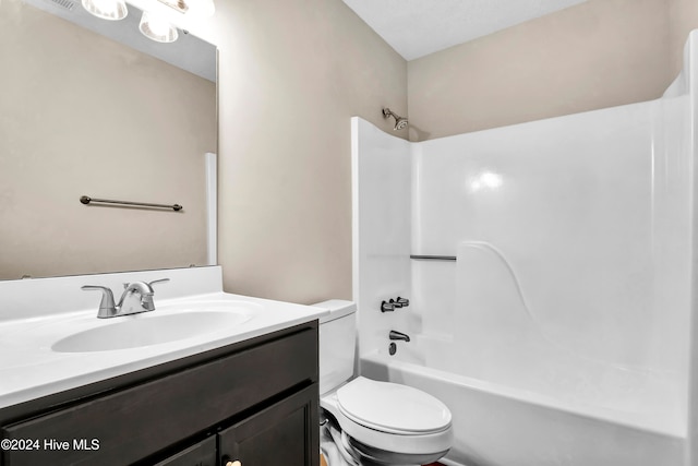 full bathroom featuring vanity, bathing tub / shower combination, and toilet