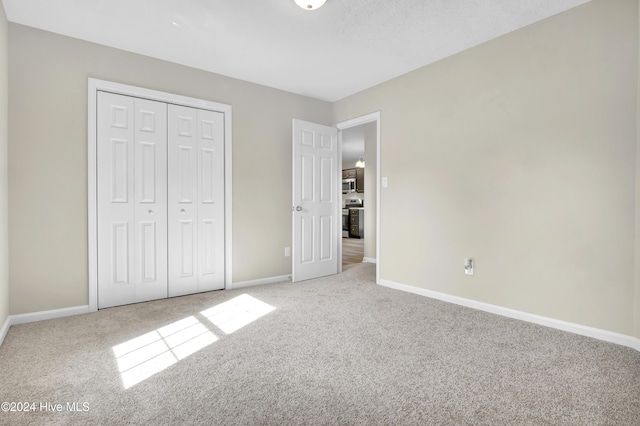 1912 Paulette Rd, Morehead City, NC 28557 - unfurnished bedroom featuring carpet flooring, baseboards, and a closet