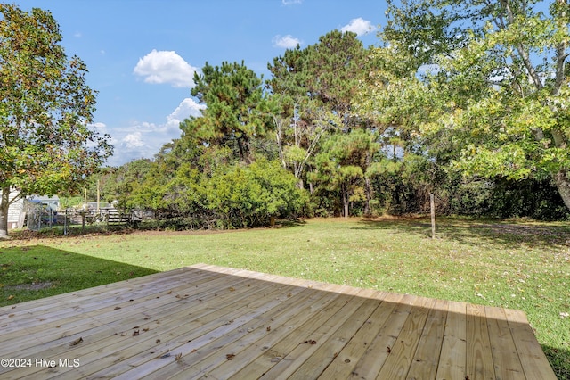 1912 Paulette Rd, Morehead City, NC 28557 - deck featuring a lawn and view of wooded area