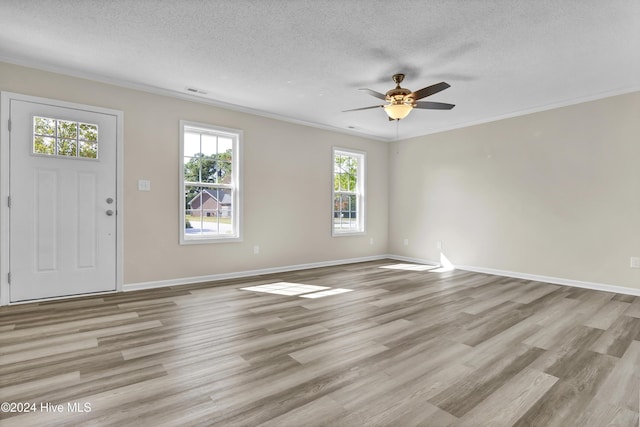 1912 Paulette Rd, Morehead City, NC 28557 - foyer entrance featuring light wood-type flooring, a textured ceiling, ceiling fan, ornamental molding, and baseboards