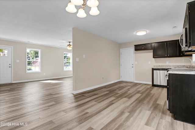 kitchen with dishwasher, light hardwood / wood-style floors, sink, light stone countertops, and ceiling fan with notable chandelier