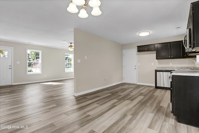 1912 Paulette Rd, Morehead City, NC 28557 - kitchen featuring stainless steel dishwasher, light countertops, a sink, and healthy amount of natural light