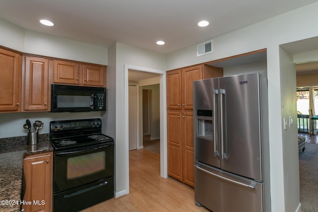 kitchen featuring recessed lighting, brown cabinetry, visible vents, black appliances, and light wood-style floors