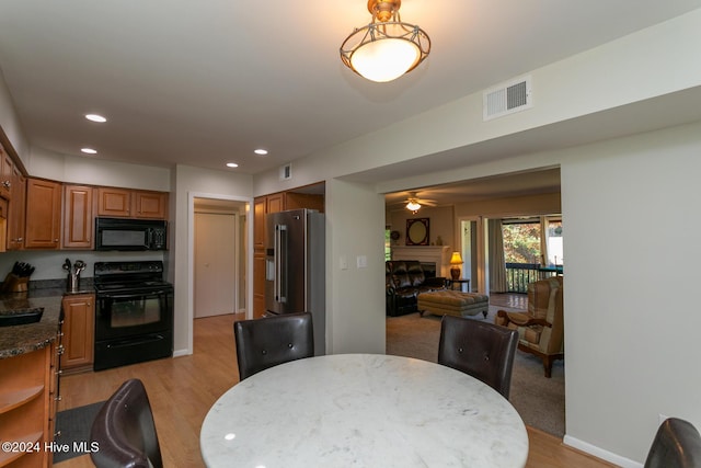 dining space featuring recessed lighting, light wood-style floors, a fireplace, and visible vents