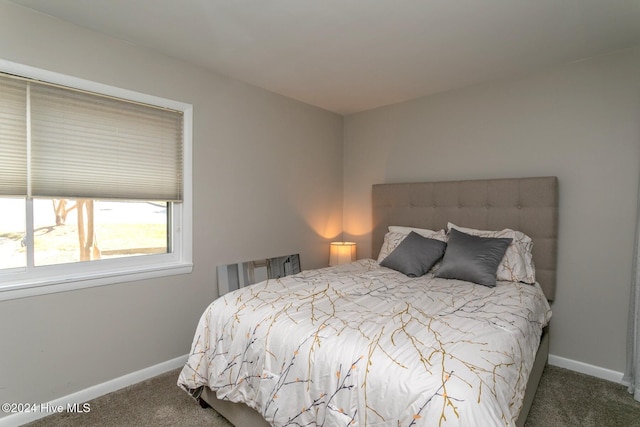 carpeted bedroom featuring baseboards