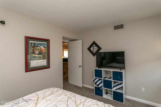 carpeted bedroom with baseboards and visible vents