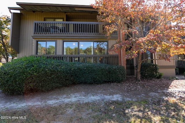 rear view of property featuring a balcony