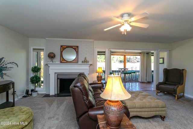 carpeted living area with a fireplace, baseboards, and a ceiling fan