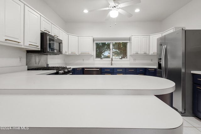 kitchen featuring blue cabinetry, black appliances, and white cabinets