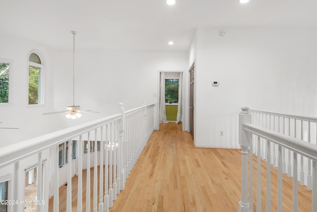 hall with plenty of natural light and light wood-type flooring