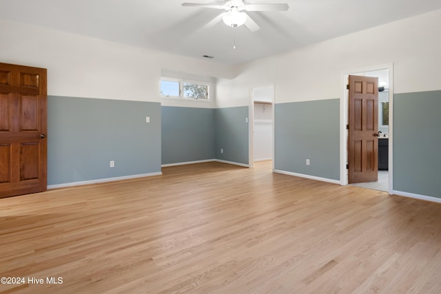 unfurnished room featuring ceiling fan and light wood-type flooring