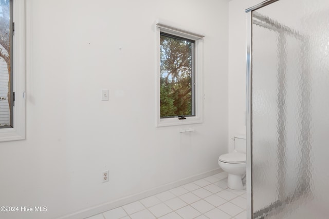 bathroom with toilet and tile patterned flooring