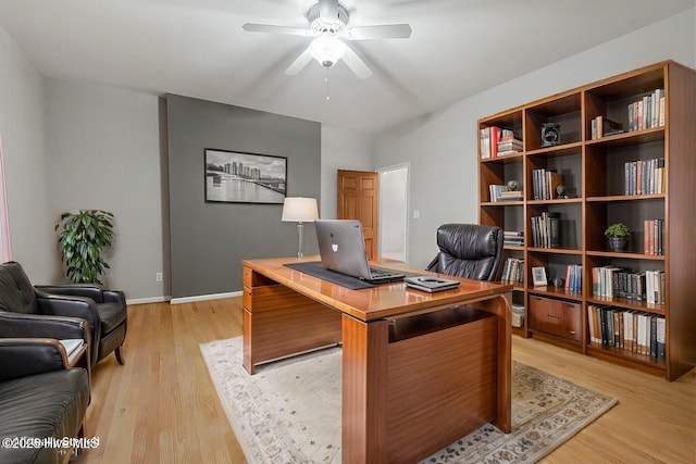 office with ceiling fan and light hardwood / wood-style flooring