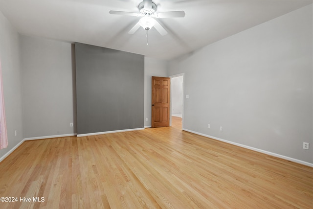 unfurnished room with ceiling fan and light hardwood / wood-style flooring