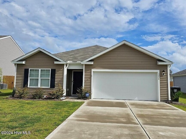 view of front of house featuring central air condition unit, a garage, and a front lawn