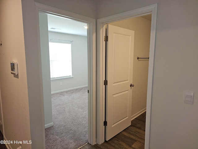 hallway with dark carpet