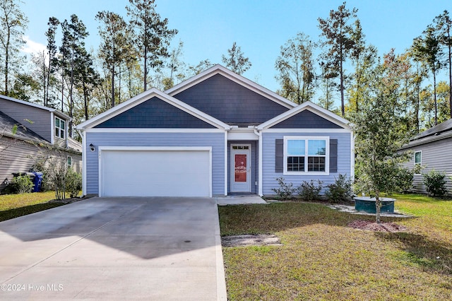 view of front of house with a front yard and a garage