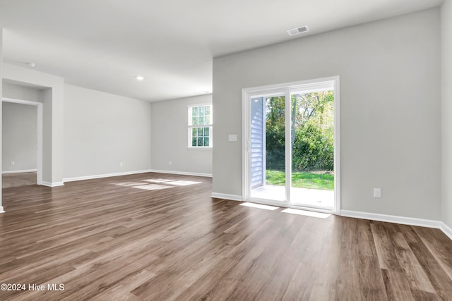 unfurnished room with wood-type flooring