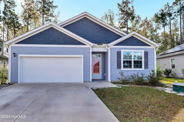 view of front of house with a front yard and a garage