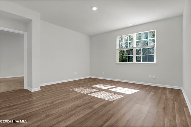 empty room with hardwood / wood-style floors