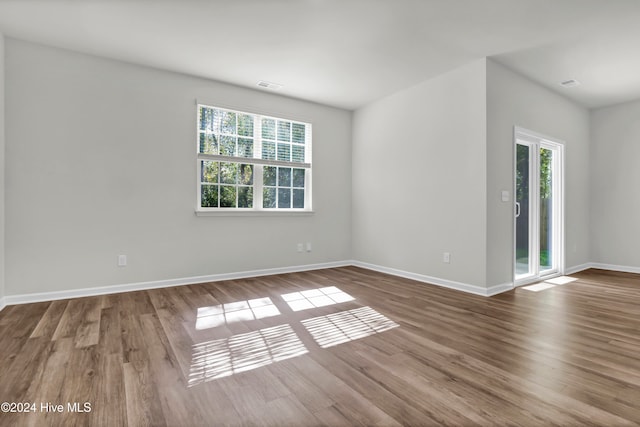 empty room featuring hardwood / wood-style flooring and plenty of natural light