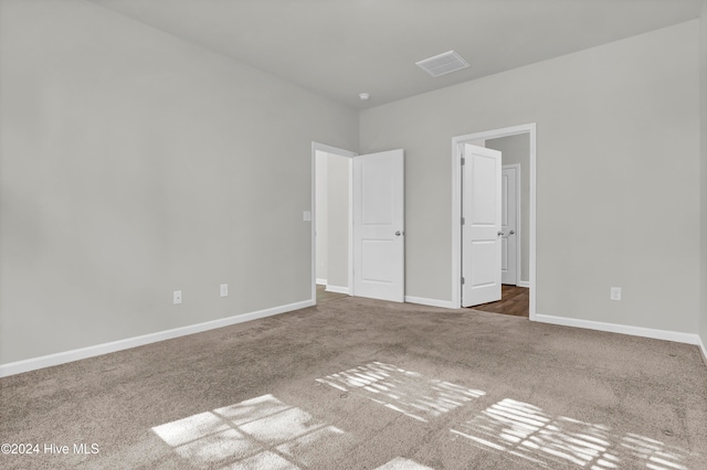 unfurnished bedroom featuring dark carpet