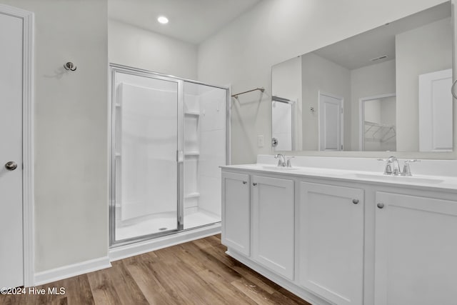 bathroom featuring vanity, an enclosed shower, and hardwood / wood-style floors