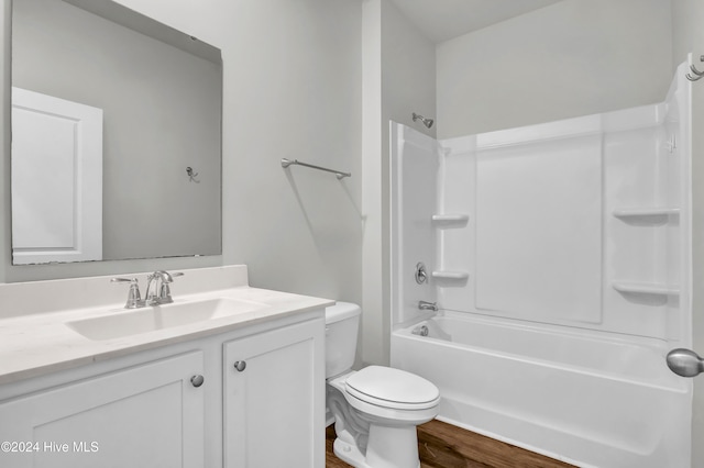 full bathroom featuring vanity, toilet, tub / shower combination, and hardwood / wood-style floors