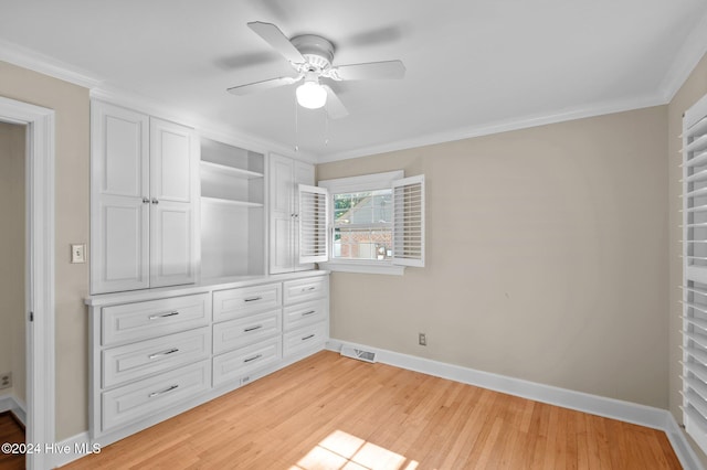 unfurnished bedroom featuring ceiling fan, a closet, light wood-type flooring, and ornamental molding