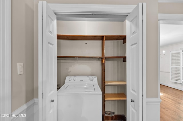 laundry area featuring light wood-type flooring and washer / dryer