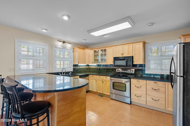 kitchen featuring appliances with stainless steel finishes, a healthy amount of sunlight, and sink