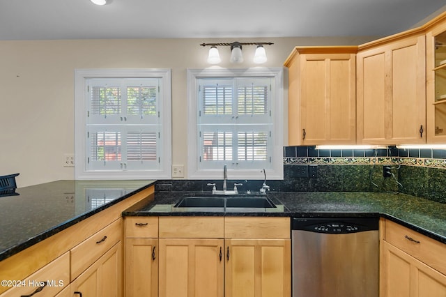 kitchen featuring dark stone counters, dishwasher, decorative backsplash, sink, and light brown cabinets