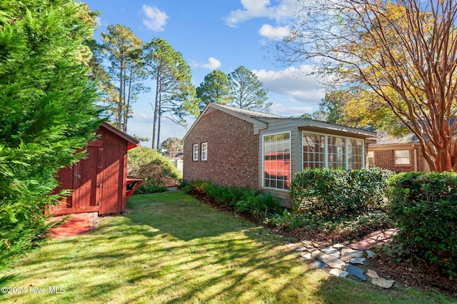 view of home's exterior featuring a yard and a shed