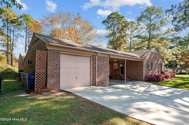 ranch-style home featuring a garage and a front yard