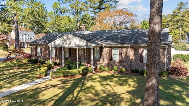 single story home with a front yard and a porch