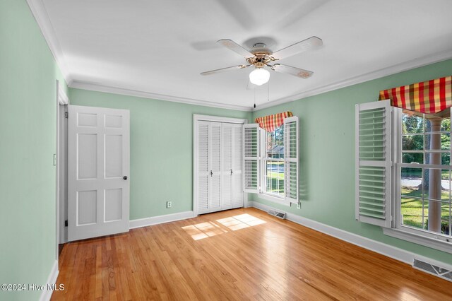 unfurnished bedroom with multiple windows, ceiling fan, and light hardwood / wood-style flooring