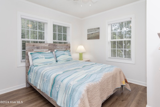 bedroom featuring ceiling fan, crown molding, and dark hardwood / wood-style flooring