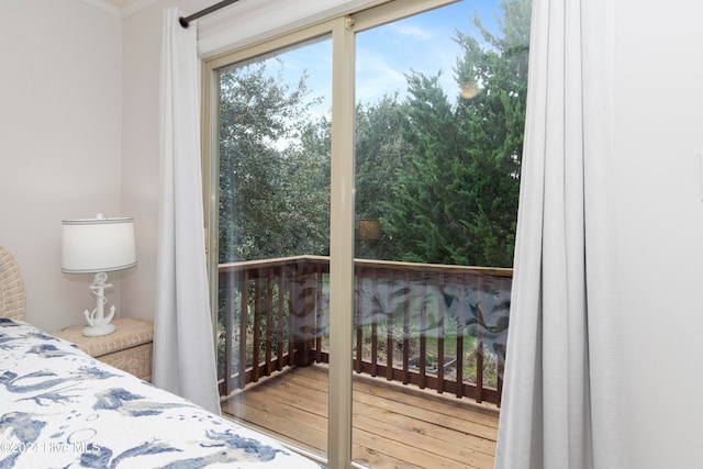 bedroom with ornamental molding and wood-type flooring