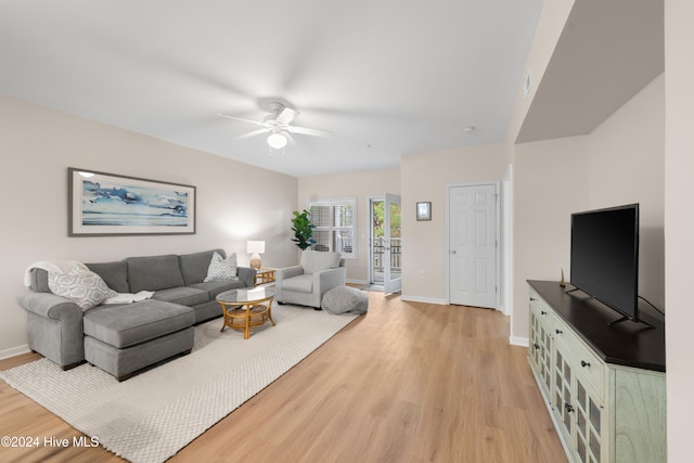 living room featuring ceiling fan and light wood-type flooring