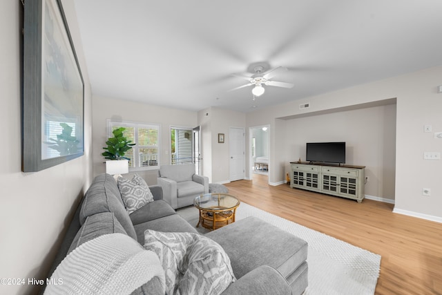 living room featuring hardwood / wood-style flooring and ceiling fan