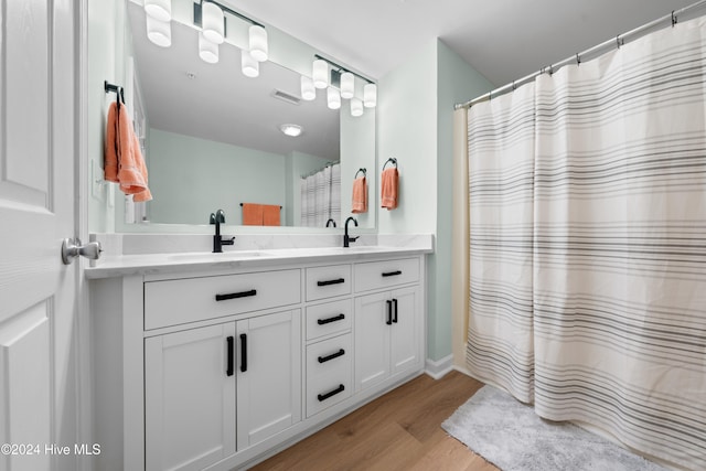 bathroom featuring vanity, hardwood / wood-style flooring, and a shower with shower curtain