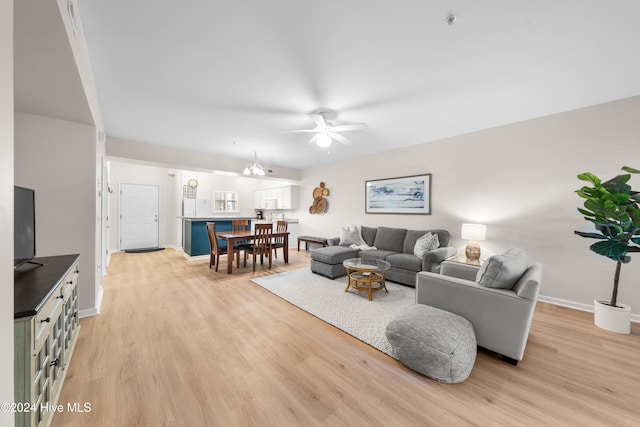 living room with ceiling fan and light hardwood / wood-style flooring