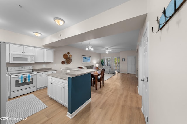 kitchen featuring a kitchen island, light wood-type flooring, white cabinets, white appliances, and ceiling fan