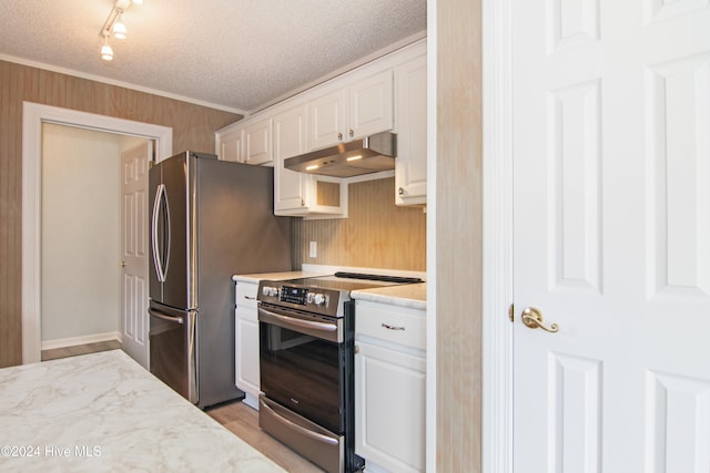 kitchen with crown molding, light hardwood / wood-style flooring, a textured ceiling, appliances with stainless steel finishes, and white cabinetry