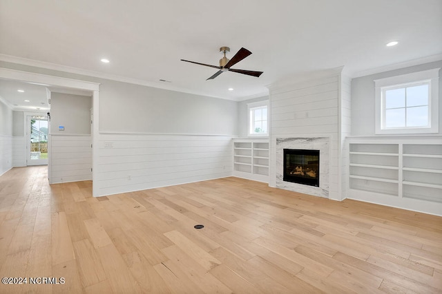 unfurnished living room with crown molding, light hardwood / wood-style flooring, and ceiling fan