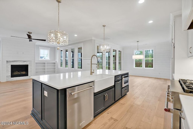 612 Waterstone Dr, Wilmington, NC 28411 - kitchen featuring stainless steel appliances, a chandelier, open floor plan, light countertops, and light wood-style floors