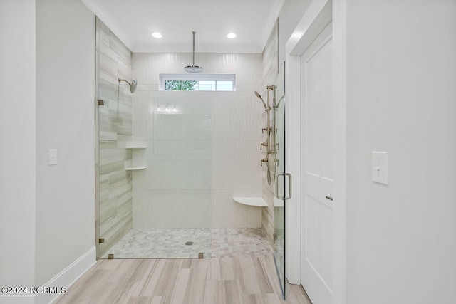 bathroom with hardwood / wood-style floors and a shower with shower door