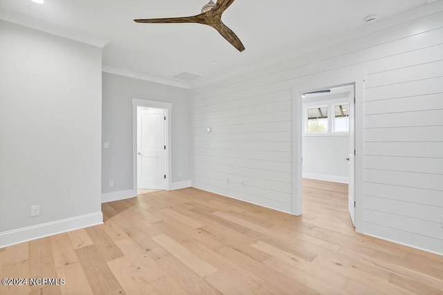 612 Waterstone Dr, Wilmington, NC 28411 - spare room with a ceiling fan, ornamental molding, light wood-style floors, wooden walls, and a smoke detector