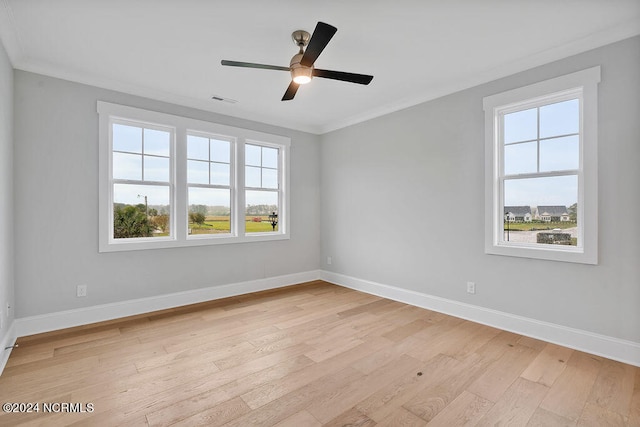 spare room with light hardwood / wood-style floors, ornamental molding, and ceiling fan